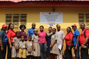 Officials of Save The Children, Reckitt Benckiser, Shomolu Local Govrrnment, teachers and pupils at the commissioning of one of the toilets