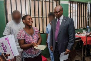 An elated mother receives her cheque from Wema Bank MD, Segun Oloketuyi, ,